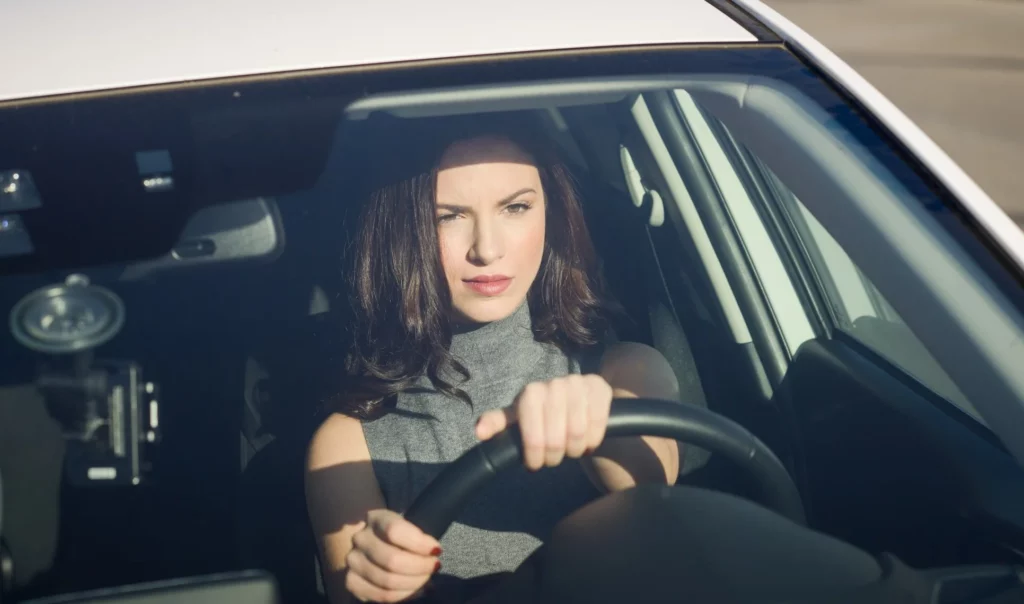 concentrated woman driving her car