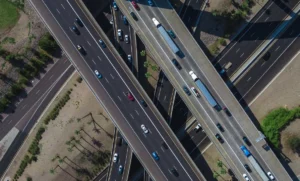 aerial view of a busy highway intersection full of traffic during daytime