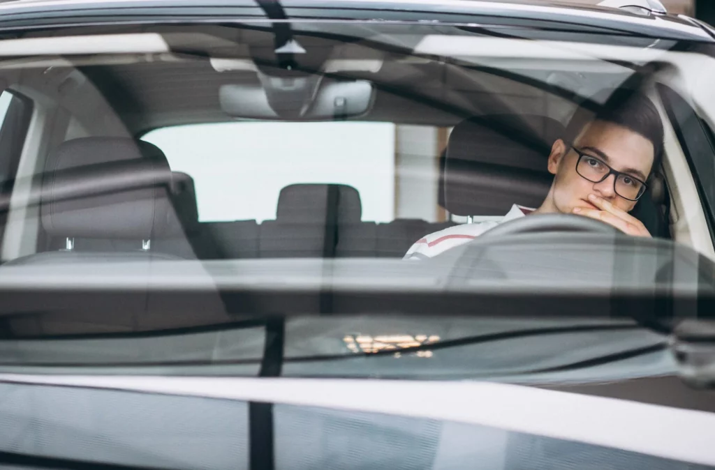 handsome man sitting in car